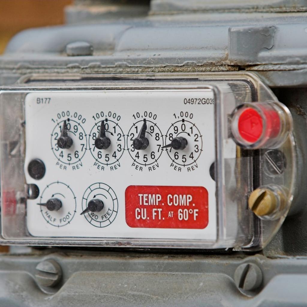 Traditional natural gas meter with multiple numbered dials.