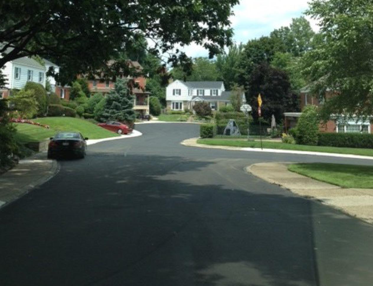 Residential street after permanent paving, smooth and fully restored.
