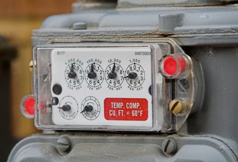 Traditional natural gas meter with multiple numbered dials.